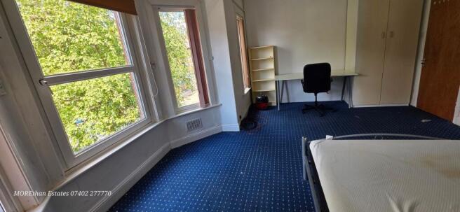 Bright and spacious bedroom with a dedicated de...
