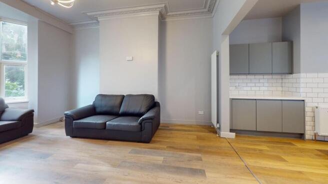 Bright and modern living room featuring large w...