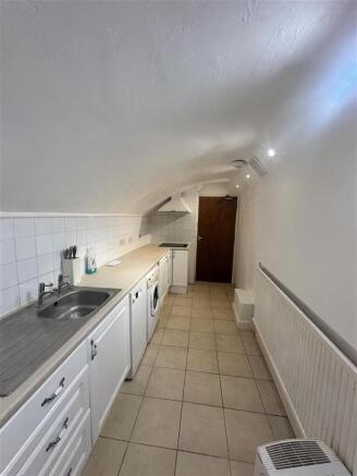 Unique vaulted galley kitchen with washing mach...