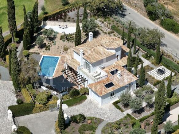 Aerial view of a frontline golf villa at Gramacho Golf Course, Algarve. Luxury property with private pool, Mediterranean garden, and large plot in Lagoa.