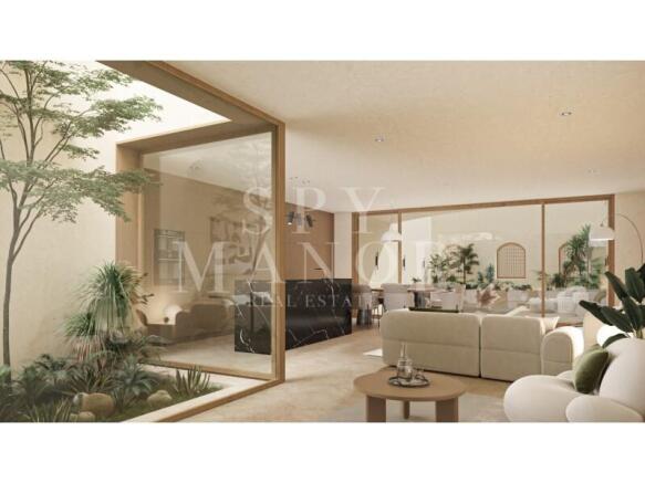 Bright open-plan living room with large glass sliding doors looking out to a modern courtyard in Casa Loko contemporary villa, Lagoa Algarve.