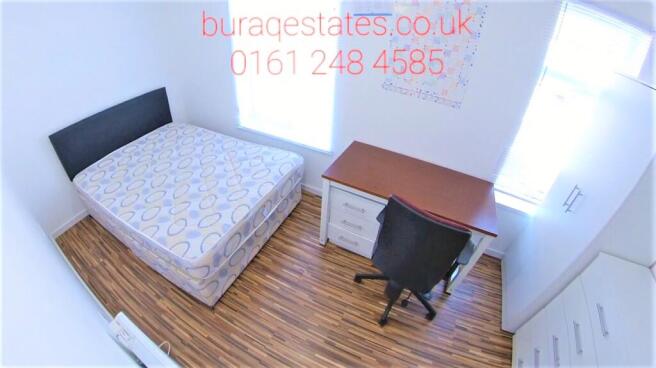 Bright, neatly presented bedroom with wood-effe...