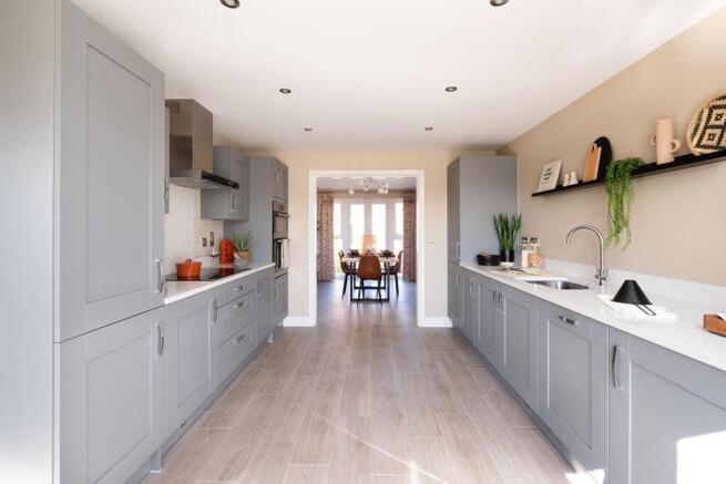 The kitchen leads through double doors to the separate dining room