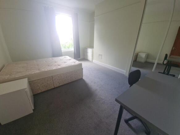 A spacious and well-maintained master bedroom f...