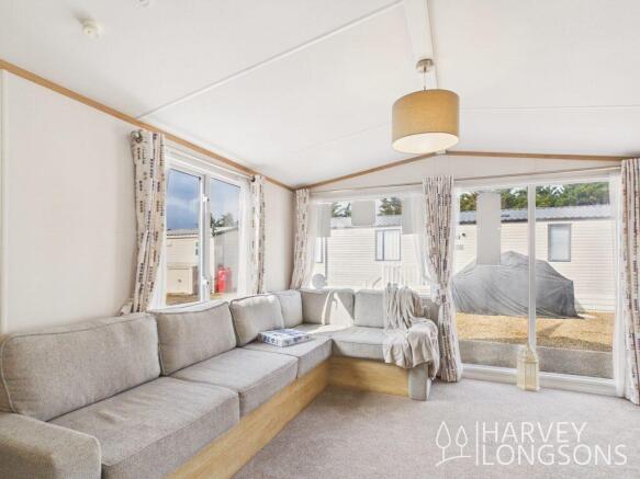 Spacious lounge with L-shaped sofa and large windo