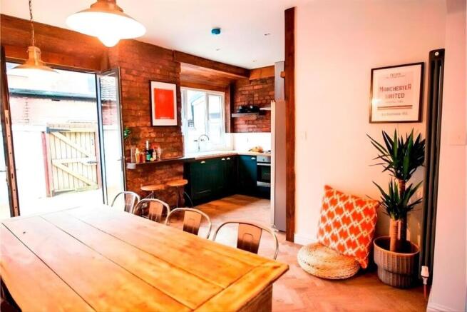 Bright kitchen-diner with large wooden table...