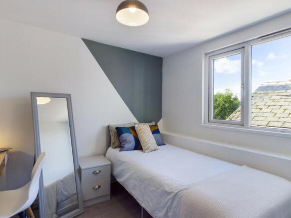 A bright and modern double bedroom with stylish...