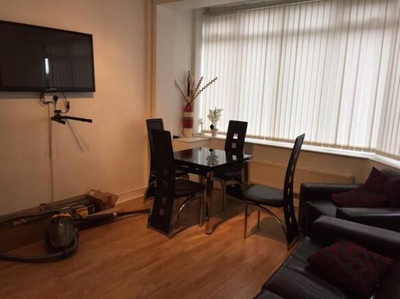 Bright living area with a large bay window, mod...