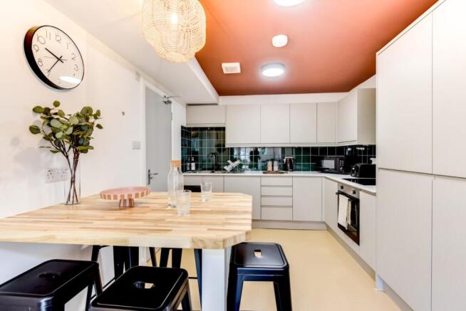 Bright modern kitchen with a wooden breakfast b...