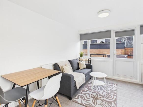 Bright, modern living room with a comfortable g...