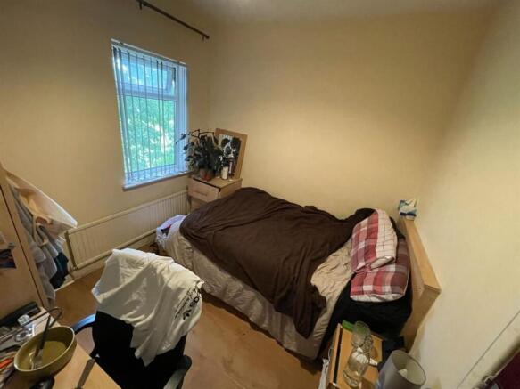 A cozy single bedroom featuring a comfy bed, a ...