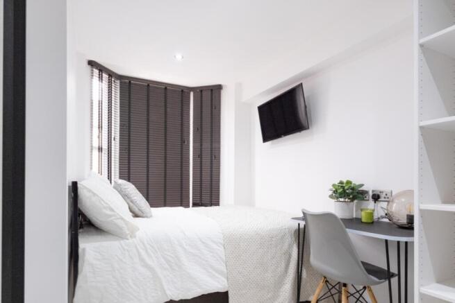 A stylish and bright double bedroom featuring m...