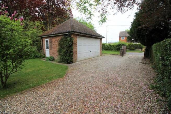 Driveway showing Detached Garage