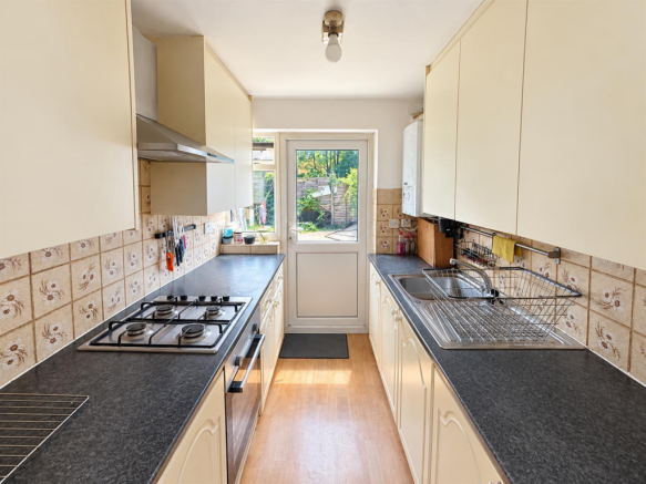 Bright Galley Kitchen with Garden View.png