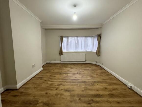 Bright, neutral living room with wood-effect fl...