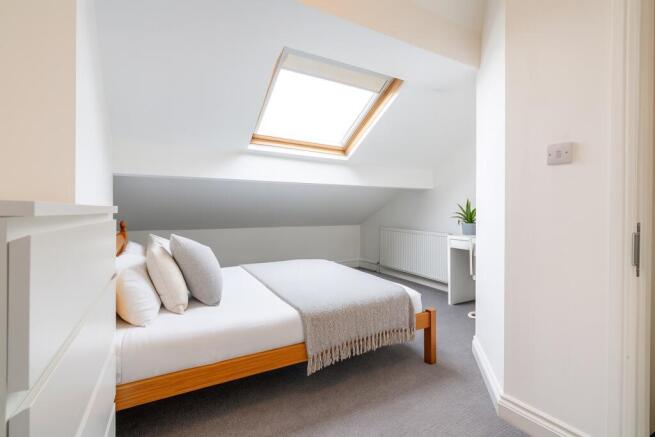 Bright, neatly styled attic double bedroom with...