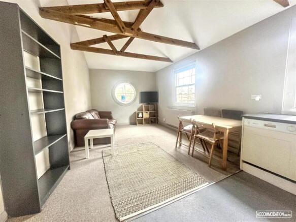 Bright lounge with exposed beams and seating...