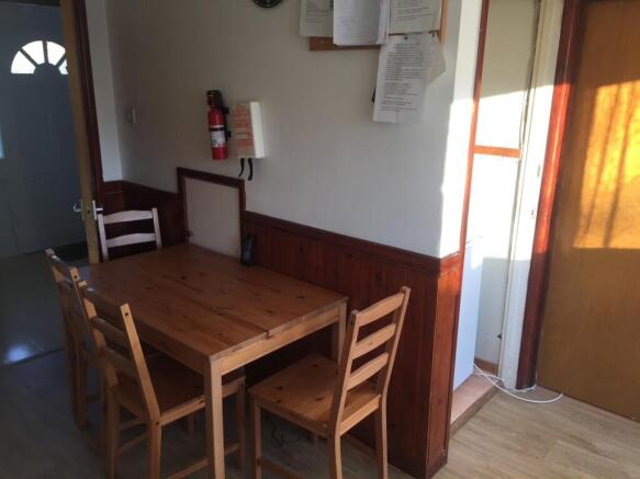 Bright eat-in kitchen area with a sturdy wooden...
