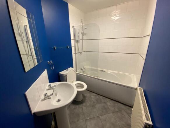 A modern and clean large bathroom featuring a b...