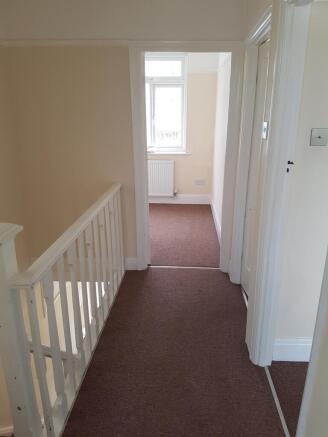 A spacious and well-maintained hallway with nat...
