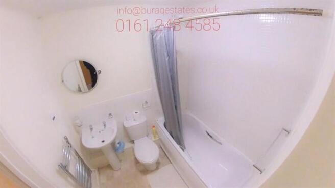 Bright, well-maintained bathroom with a bathtub...