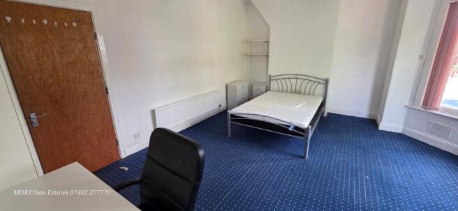 Spacious bedroom with double bed and study desk...