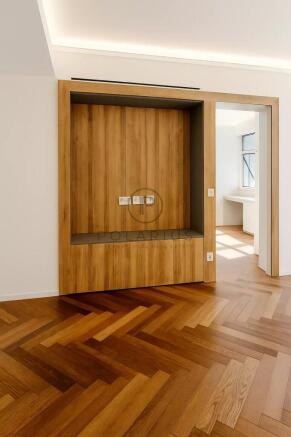 The image shows an empty room with wood herringbon