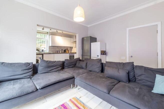 Bright, modern living room with a large L-shape...