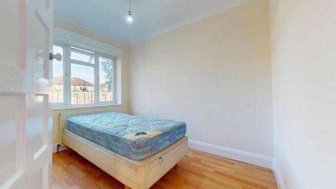 Bright double bedroom with wooden flooring...