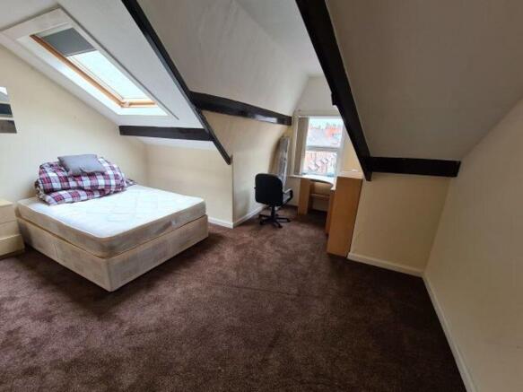A cozy and well-maintained bedroom with a comfo...