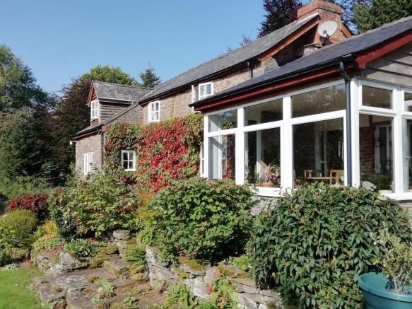 Conservatory, opening onto a stone patio