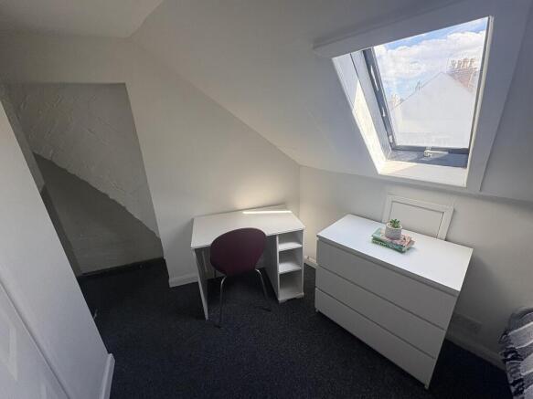 Bright attic single room with desk and storage...
