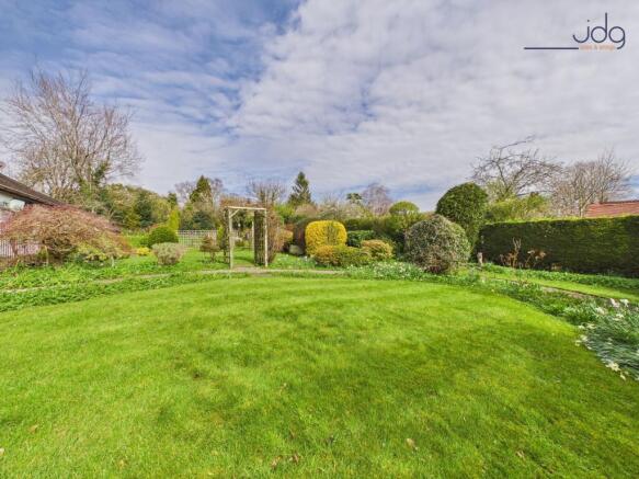Wraparound mature gardens with expansive lawns