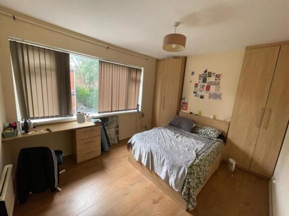 A well-maintained bedroom featuring a comfortab...