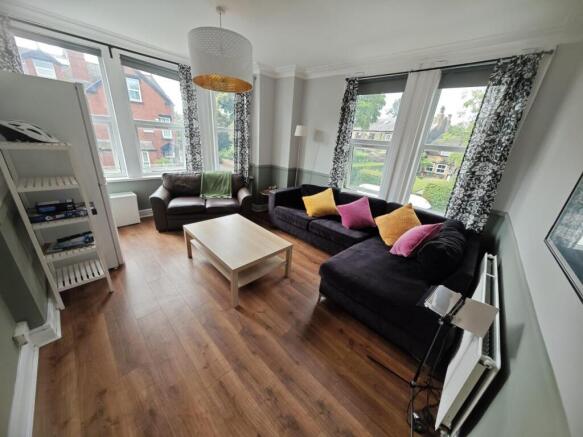 Bright and welcoming living room featuring larg...