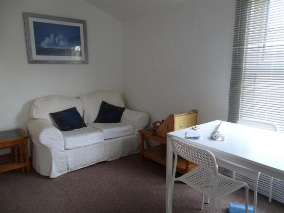 Bright, neatly presented living area with a com...