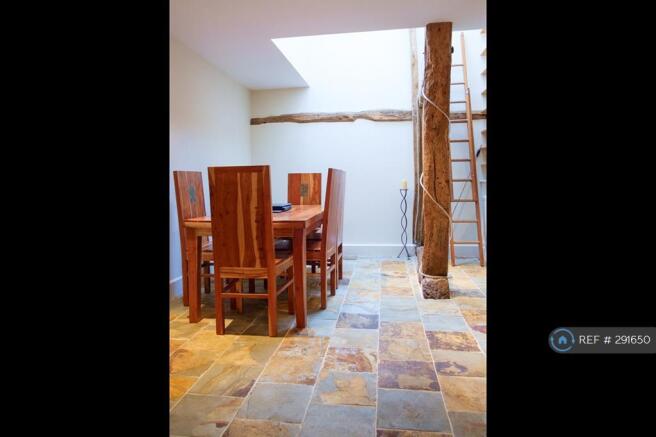 Dining Room With Double Height Ceiling At Rear