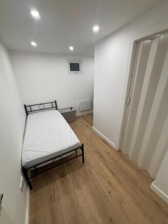 Bright modern bedroom with stylish wood floorin...