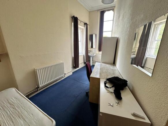 A spacious and well-lit double bedroom featurin...