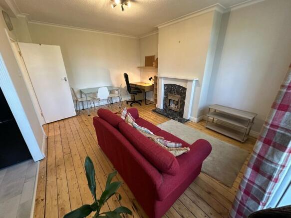 Spacious living area with character fireplace...