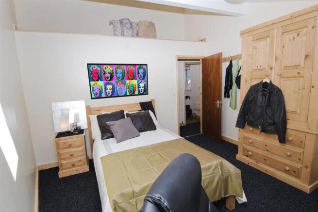 Bright double bedroom with ample storage space ...