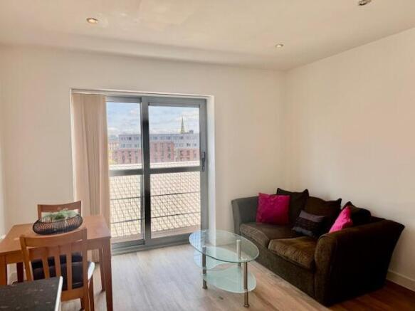 Bright living area with large window and view...