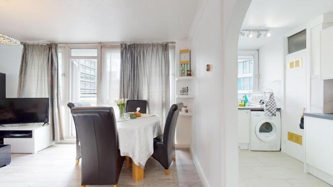 Bright and spacious living room featuring large...