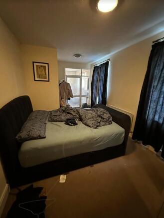 A cozy double bedroom with good natural light a...