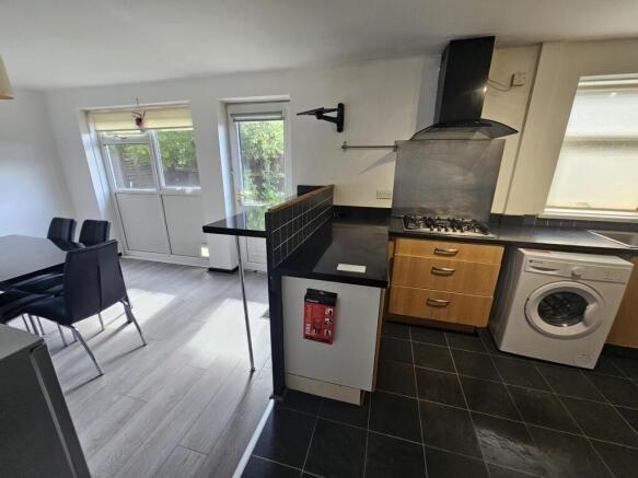 Modern kitchen area with ample natural light, f...