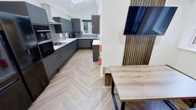 Modern sleek kitchen with dining and media wall...