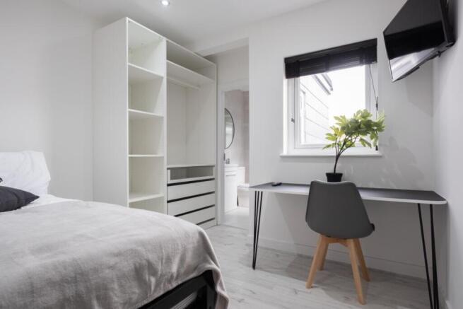 A bright and modern double bedroom featuring a ...