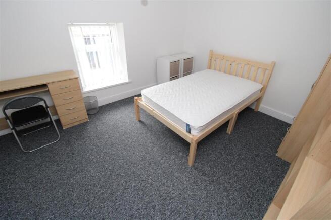 Spacious bedroom with a double bed and desk...