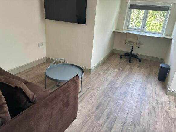 Bright lounge area with integrated study desk...
