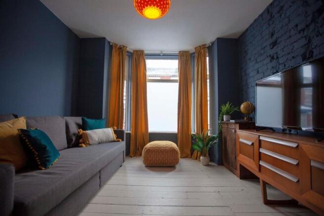 Stylish living room with bay window and TV...